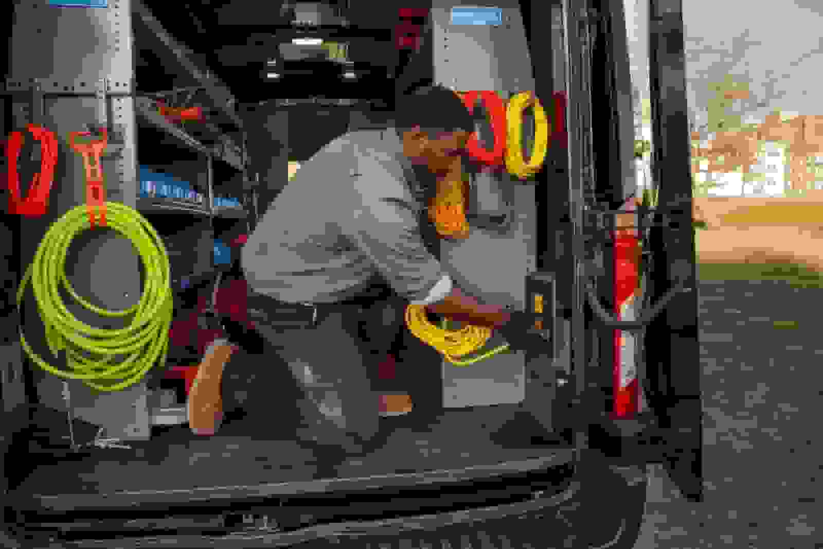 Person in a work van with colorful extension cords